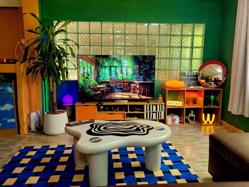 a living room with a tv and a zebra stool at LowKey Villa - Quiet Jungle Beach Escape in Ko Kood
