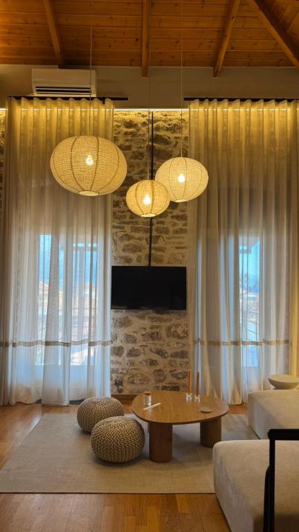 a living room with two lights and a table at Nia The Nest in Nafpaktos