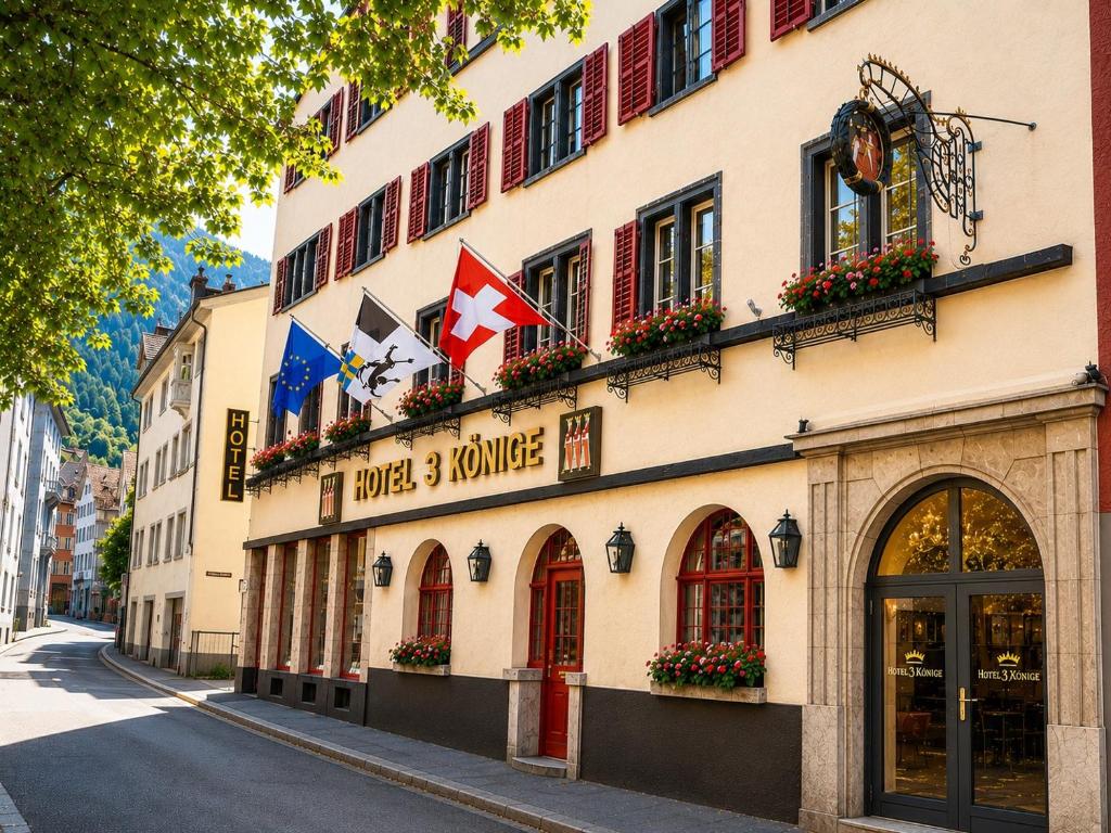 a building with flags on it on a street at Hotel Drei Könige in Chur