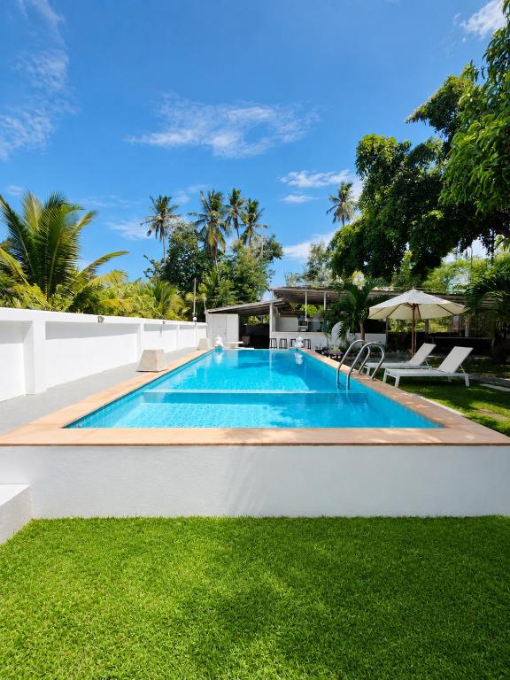 a swimming pool in the backyard of a villa at Villa Giacomelli Samui in Taling Ngam Beach