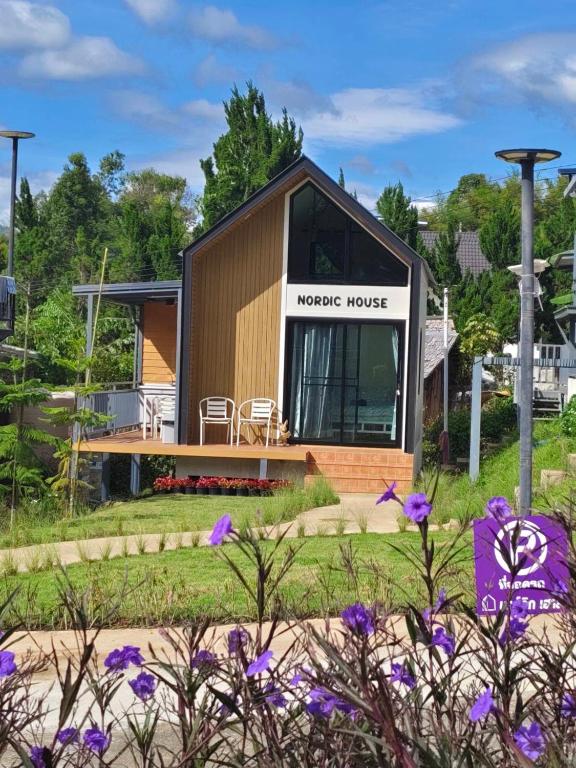 a house with a large window on the side of it at บ้านนอร์ดิก เฮาส์ เขาค้อ in Khao Kho