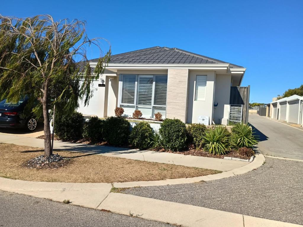 a house with a palm tree in a driveway at Eden beach retreat in Jindalee