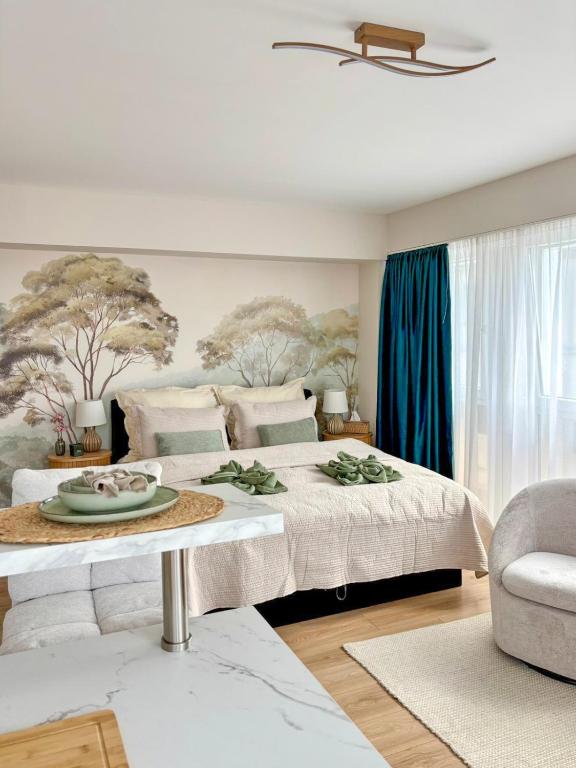 a bedroom with a large bed with a tray of food on it at HelloWine Apartman II in Eger