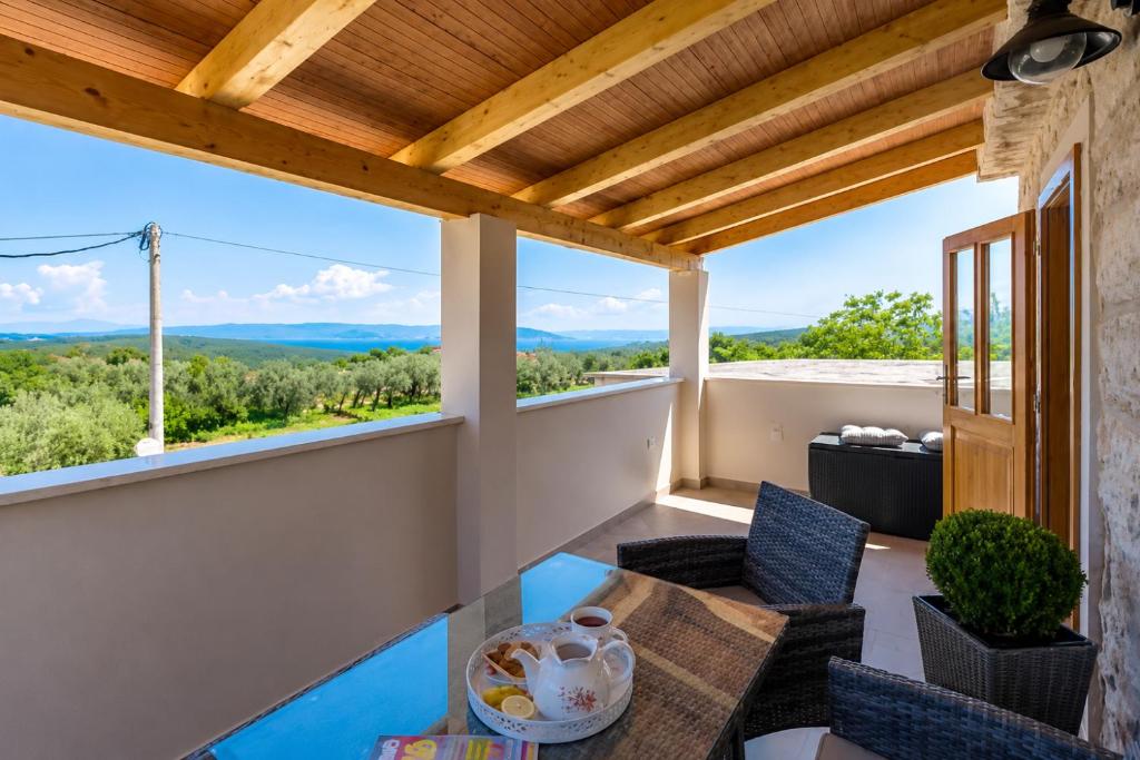 a view from the balcony of a house with a table and chairs at Kuća za odmor Aurora in Kavran