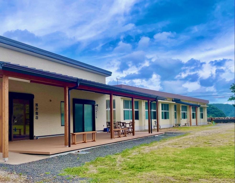 a row of modular buildings on a field at あらとんとんの宿 in Setouchi