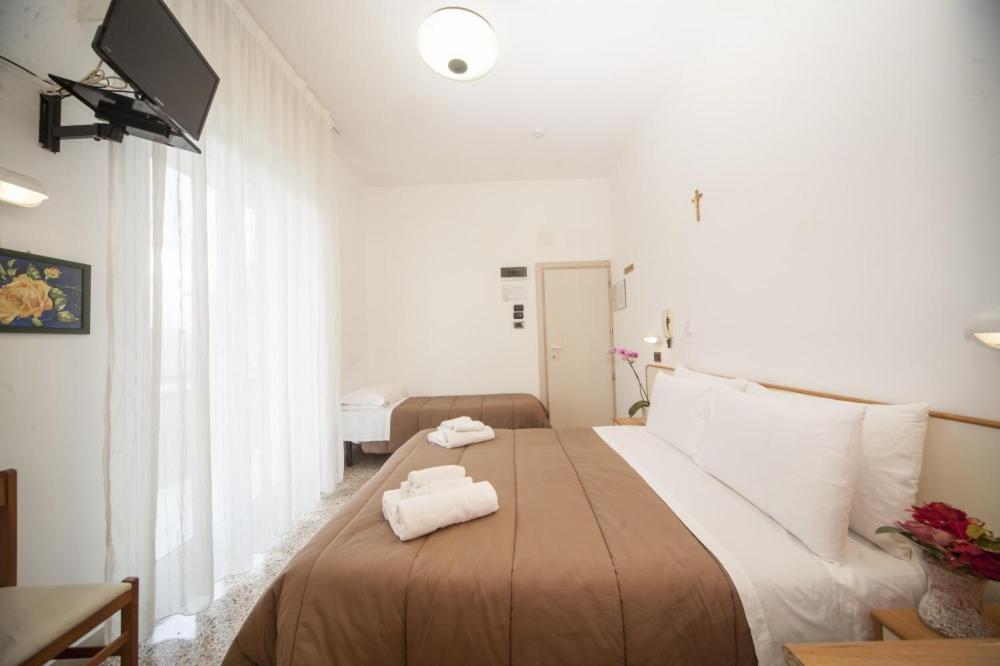 Postel nebo postele na pokoji v ubytování Hotel Zurigo
