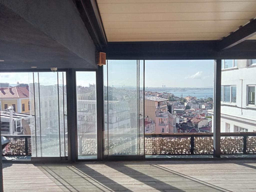 a view of a city from a building with glass windows at ATiK PERA in Istanbul