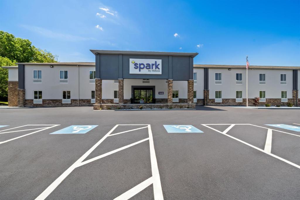 an empty parking lot in front of a building at Spark by Hilton Milford Boston in Milford