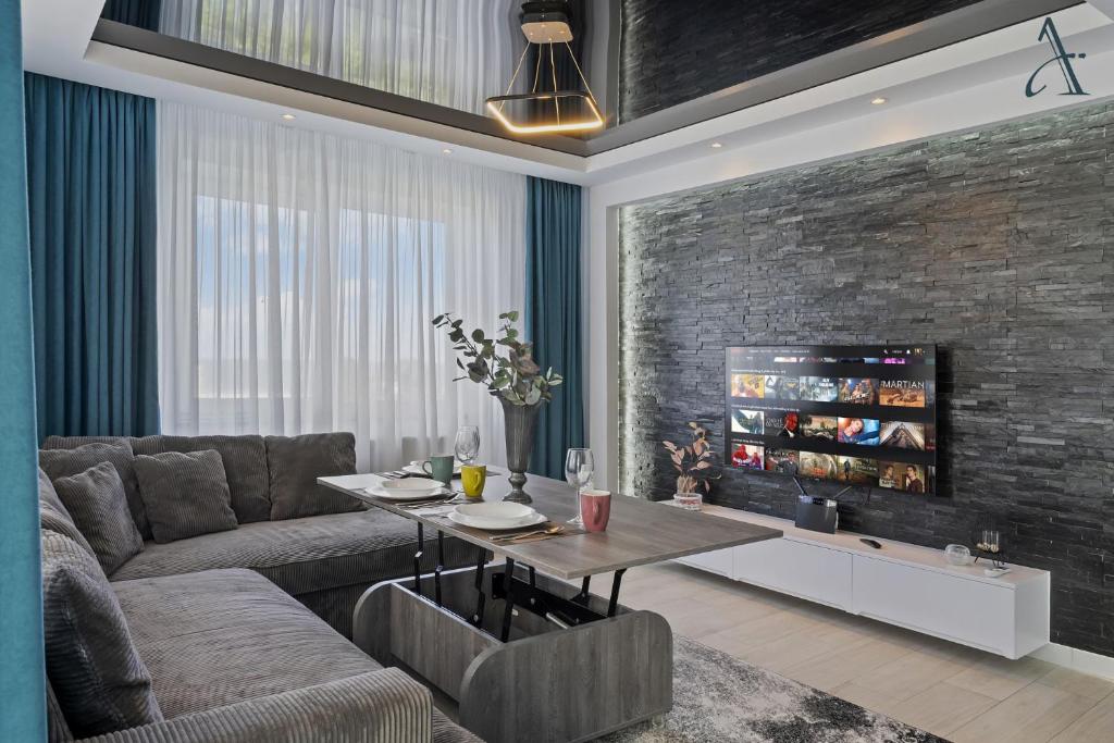 a living room with a couch and a table at Apartment in MoonLight Residence in Mamaia