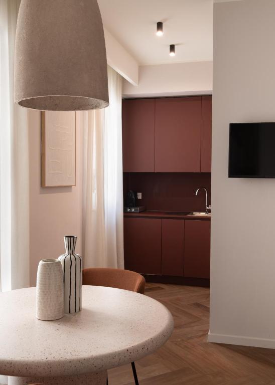 a table with a vase on it in a kitchen at Fill's Luxury Design Apartments 100m from the Beach in Rimini