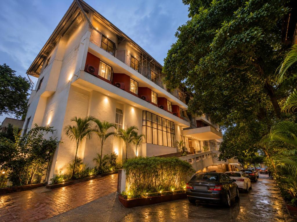 a building with cars parked in front of it at Hotel Garden Panvel - Near Navi Mumbai Airport in Navi Mumbai