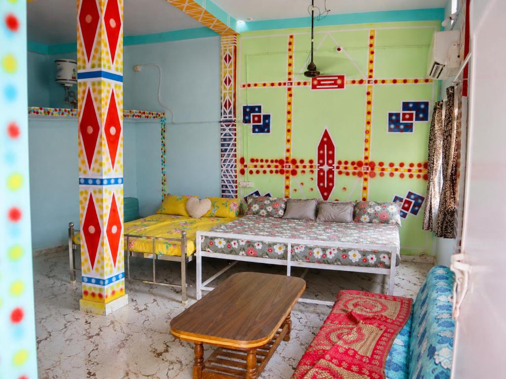 a living room with a couch and a table at Harshvardhan Lodge in Narsimhapur