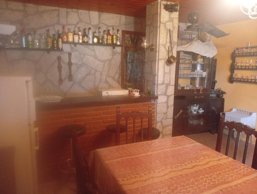 a dining room with a table and a bar at Elena's bar loft in Poio