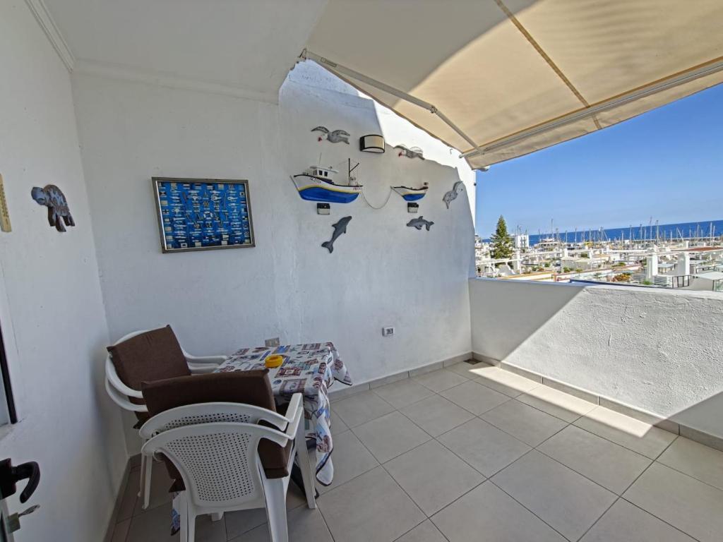 a room with a table and chairs and a window at Casa Kevin in Puerto de Mogán
