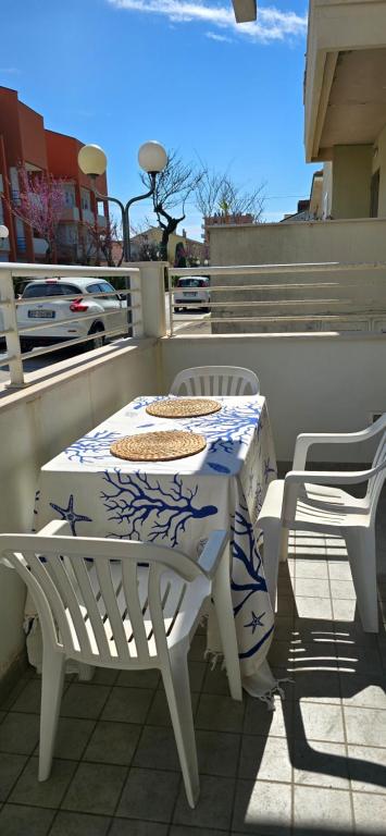 a white table and chairs on a balcony at Casa Ida in Marotta