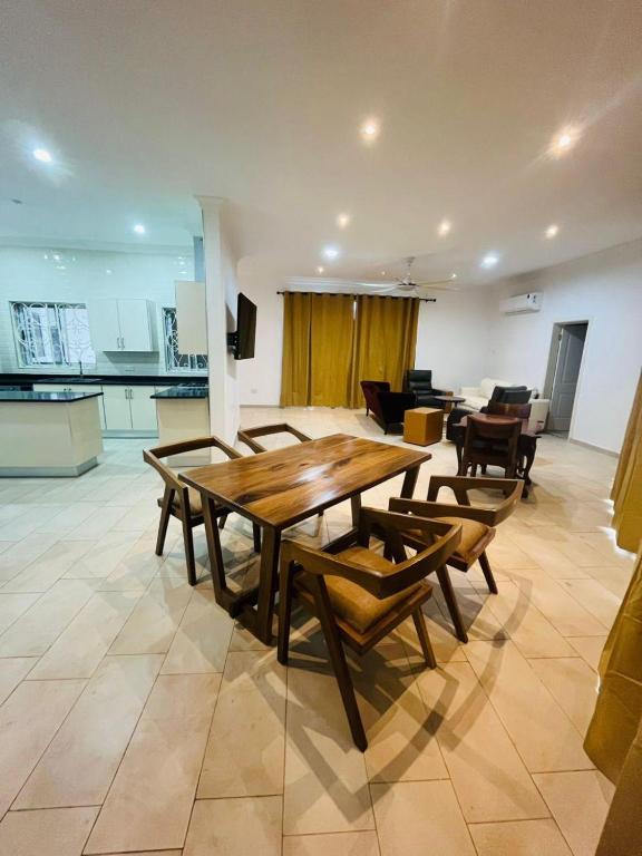 a living room with a wooden table and chairs at Teiman Apartments in Teiman