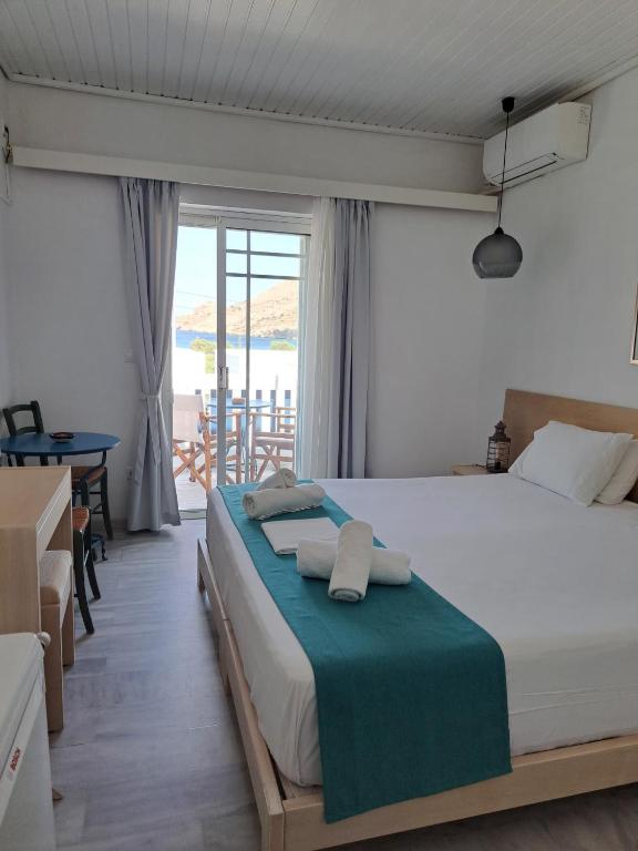 a bedroom with a bed with towels on it at Stefos Rooms in Galissas