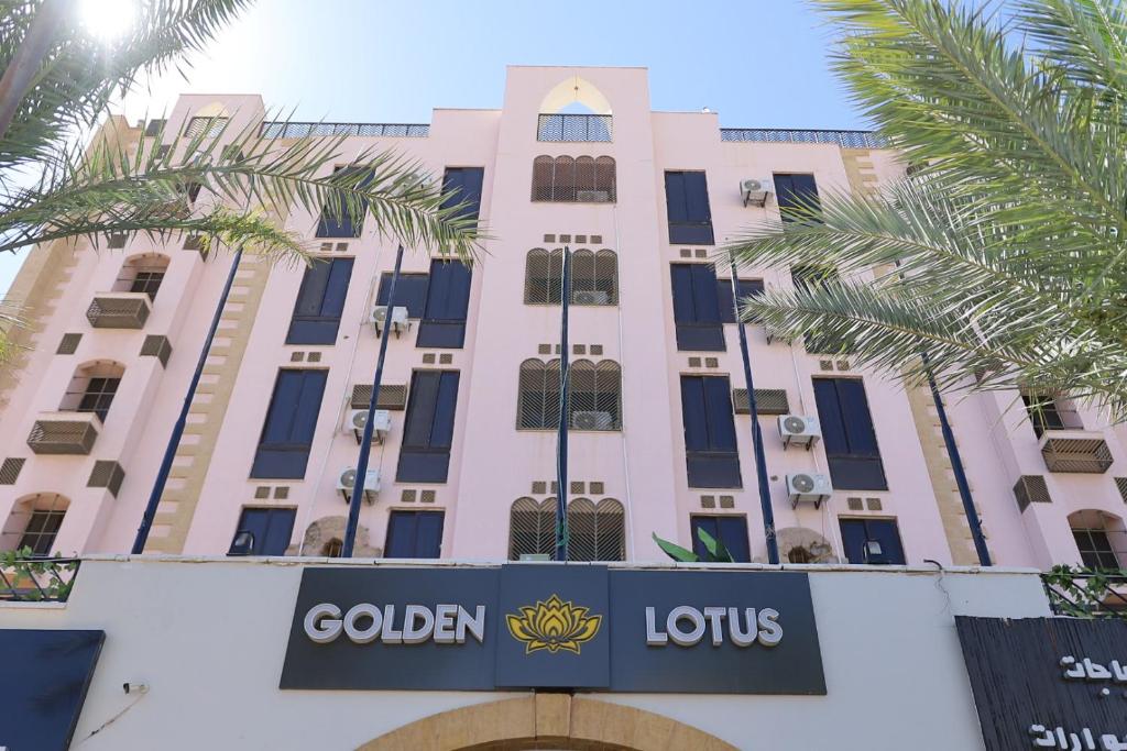 a building with a hotel sign in front of it at Golden Lotus hotel by Trend in Aqaba