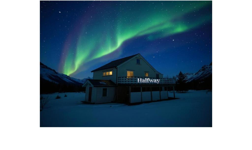 a house with the aurora in the sky at Halfway in Kabelvåg