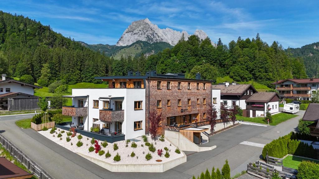an aerial view of a house with a mountain in the background at Apartment Streif LXL in Kirchdorf in Tirol