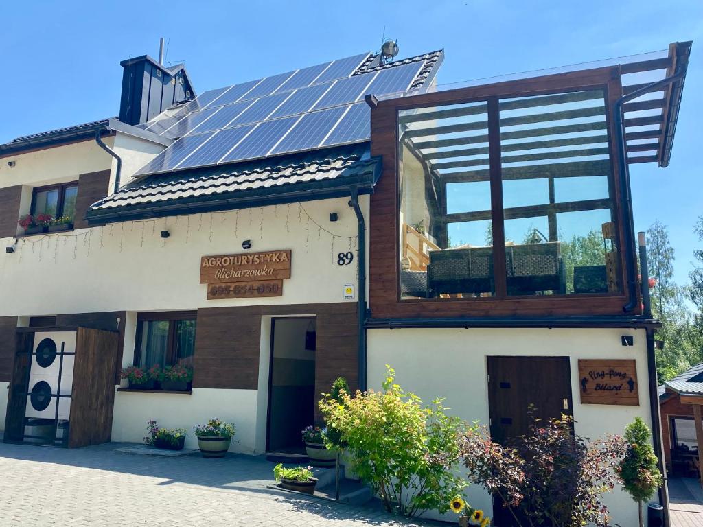 a building with solar panels on the roof at Agroturystyka Blicharzówka Noclegi in Bukówka