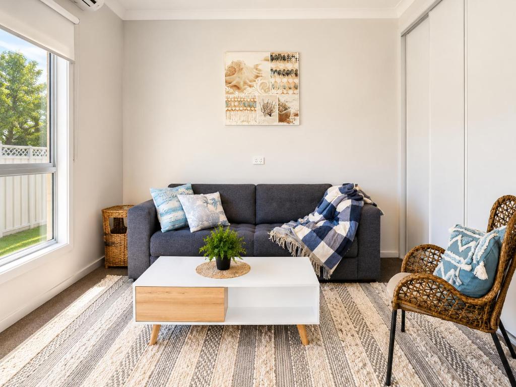 a living room with a couch and a table at Between the Blue Studio in Blacksmiths