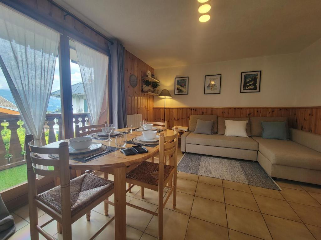 a living room with a table and a couch at Residence Isabella - By Care Concierge in Saint-Gervais-les-Bains