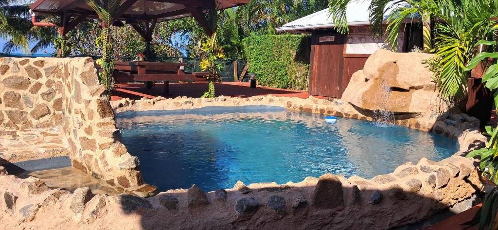 a large pool of water in a rock structure at Pension LE PASSAGE in Vaitoare