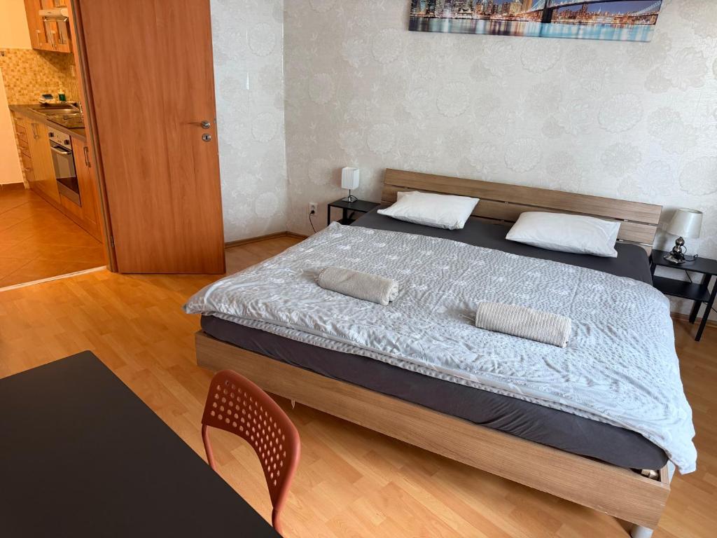 a bedroom with a bed with two pillows on it at KEY Accommodation Pellicova in Brno