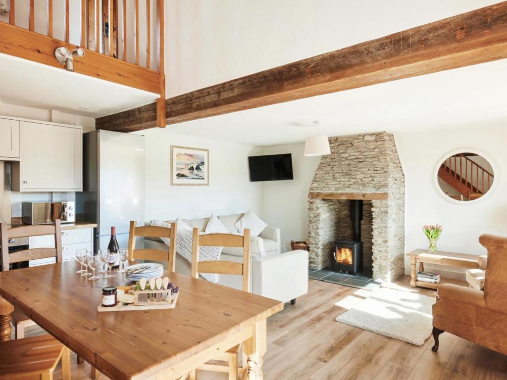 a kitchen and living room with a table and a fireplace at Willow - Ukc9530 in Barnstaple