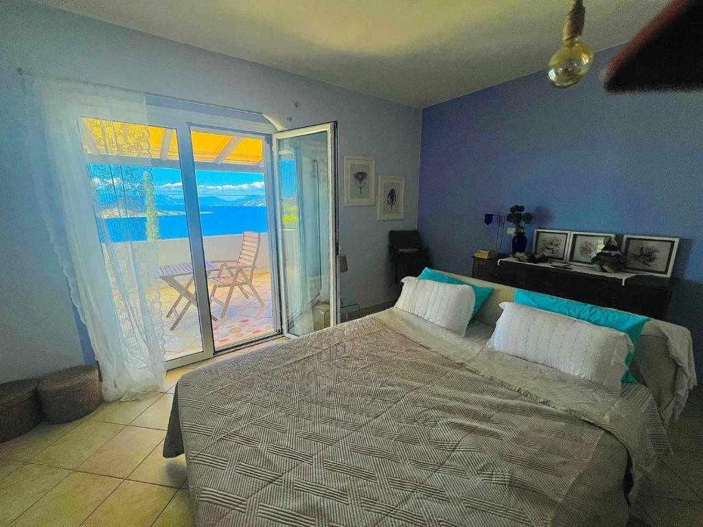 a bedroom with a bed with a view of the ocean at Myrto Signature Villa - Aegina in Aegina