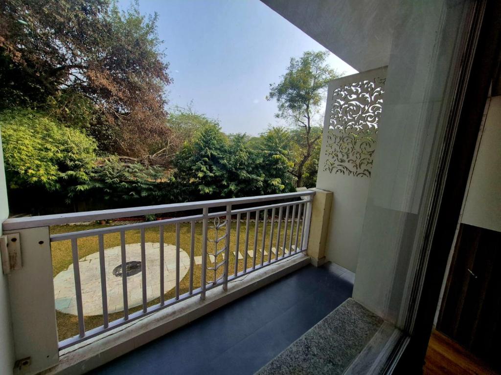 a balcony with a view of a garden at Arch Place in Gurgaon