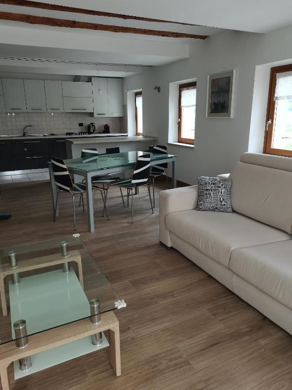 a living room with a couch and a table at Nancy House in Longarone