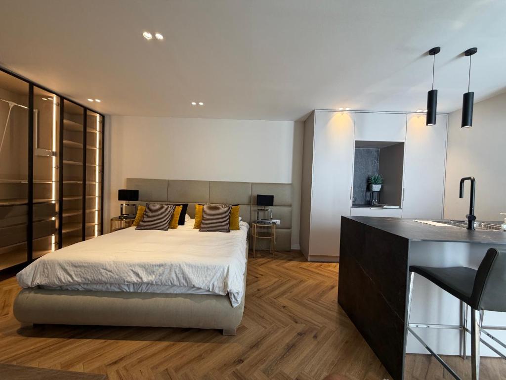 a bedroom with a king sized bed and a kitchen at rooms 48 in Eilat