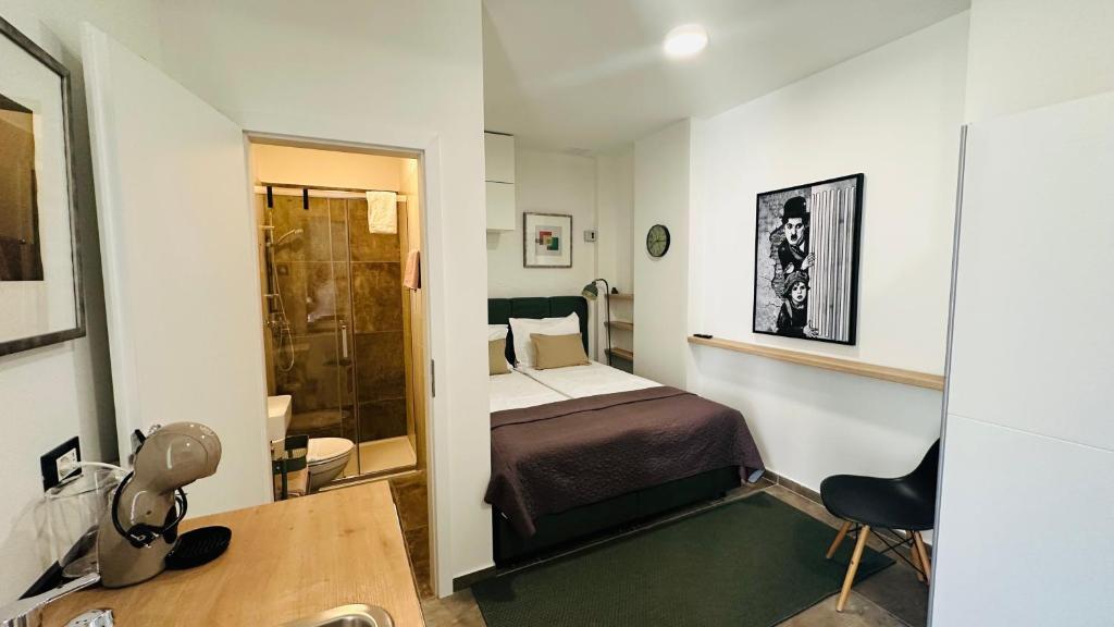 a small room with a bed and a bathroom at City Room Filip without window in Poreč