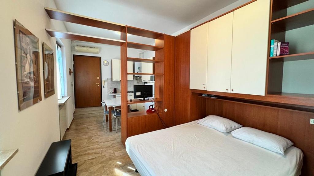 a bedroom with a bed and a desk in it at I Liutai 2P in Cremona