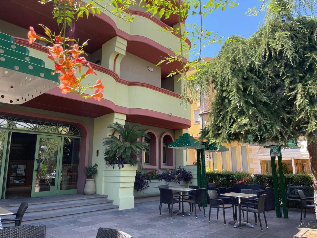 a restaurant with tables and chairs in front of a building at Hotel Twins in Vasto