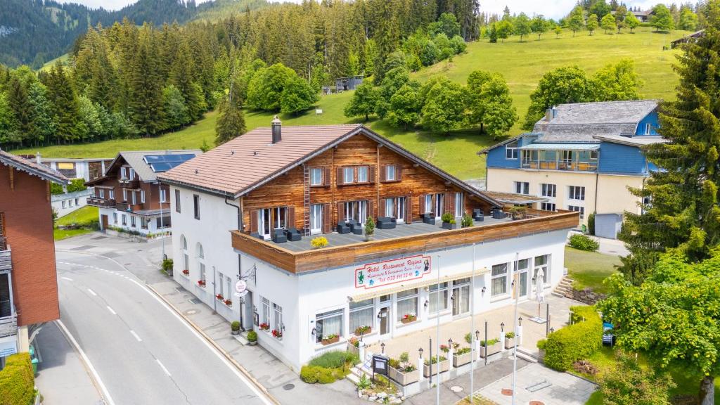 an aerial view of a building in a village at self-check-in Hotel Regina Beatenberg in Beatenberg