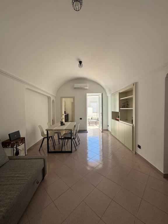 a large living room with a table and chairs at Dietro la Piazzetta in Capri