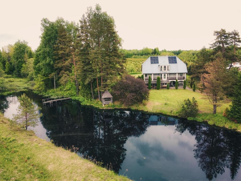 an aerial view of a house next to a pond at Ezernieki in Valka