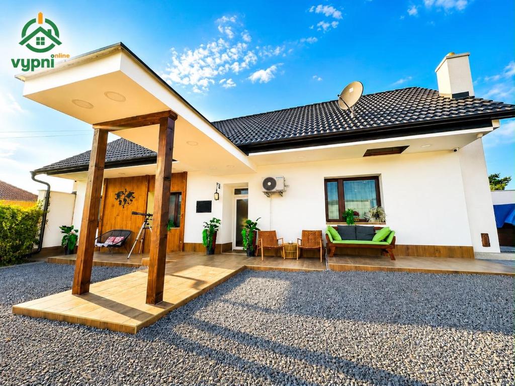 a house with a large open patio in front of it at Chalupa Oslany in Oslany