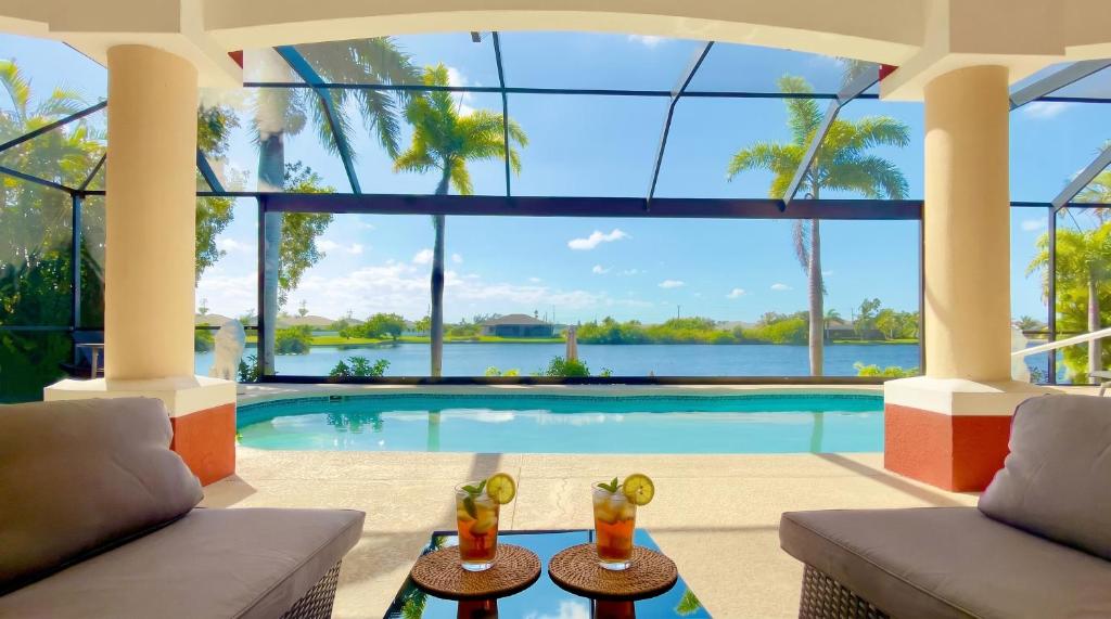 a villa with a swimming pool with a couch at Villa Princess in Cape Coral
