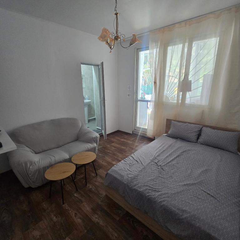 a bedroom with a bed and a couch at Happy House Garden in Plovdiv