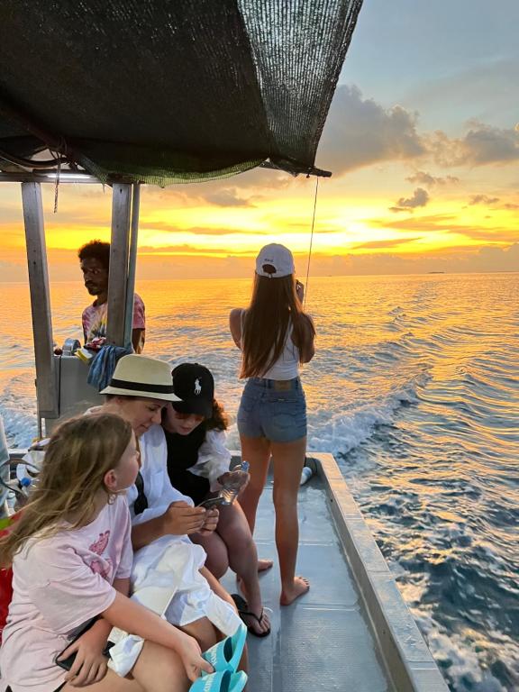 a group of people sitting on a boat in the water at Palms hotel and Spa in Fulhadhoo