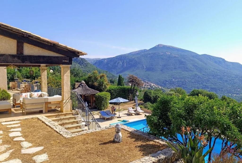 a villa with a swimming pool and a mountain at Loup Castel Boutique Hotel B&B in Le Bar-sur-Loup