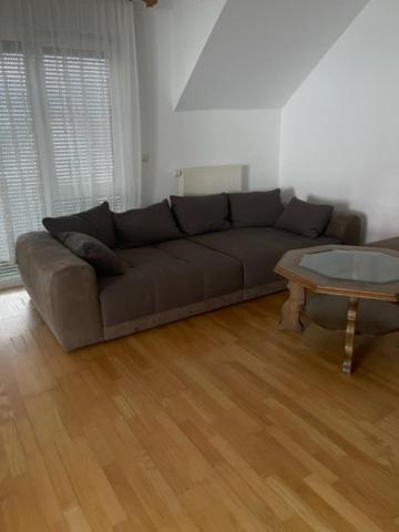 a living room with a couch and a table at Ferienwohnung Habichtswald in Habichtswald