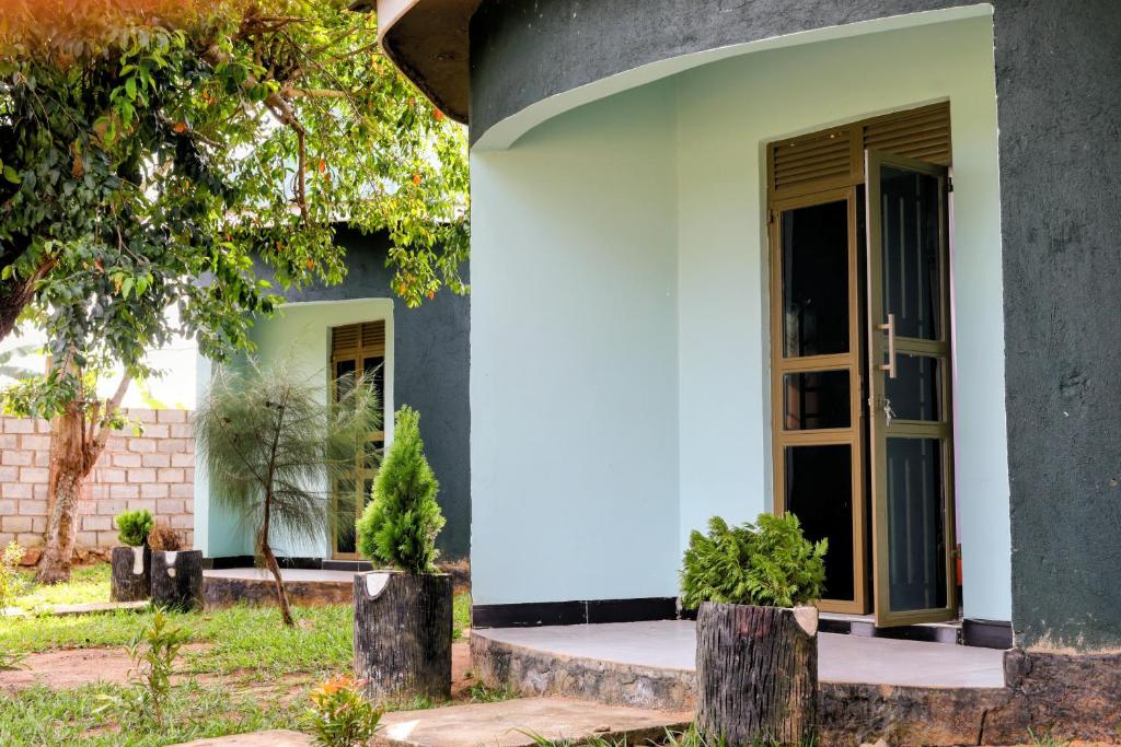 a white house with an open door at Dream Land Resort Beach in Mpigi
