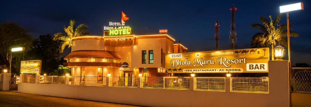 a building with a sign for a bar at night at Hotel Dhola Maru in Kota