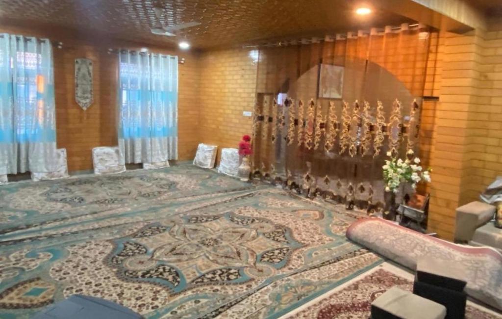 a room with a large rug on the floor at Visiting Villa in Srinagar