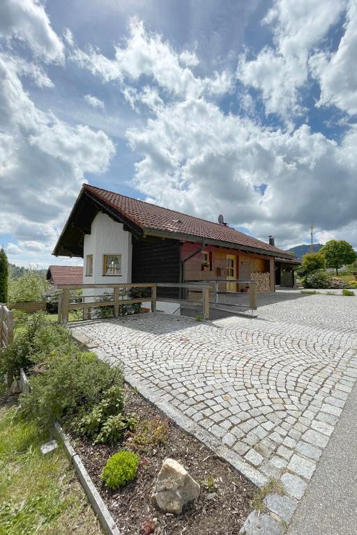 a building with a stone walkway in front of it at Apartman Pepa in Bayerisch Eisenstein